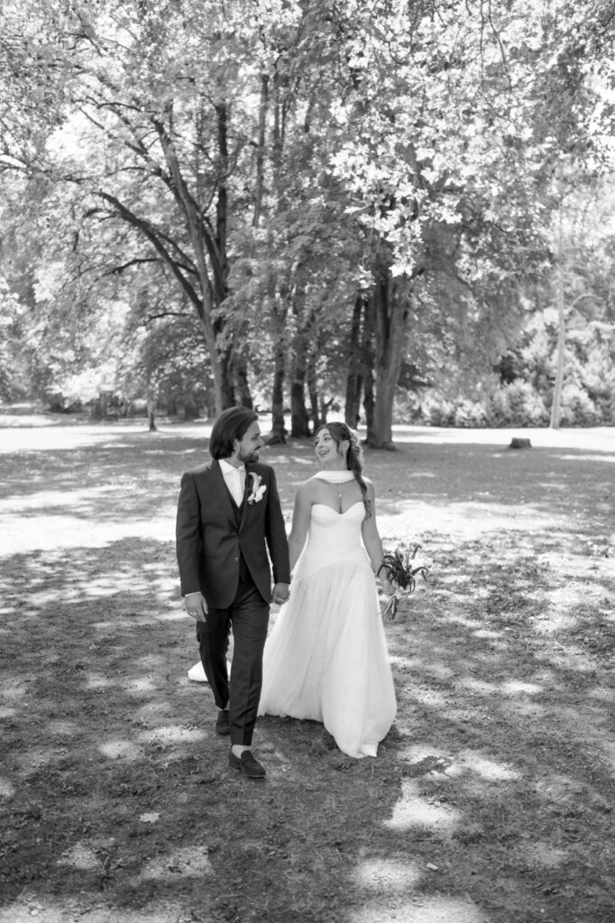 Les mariés marchent sous les arbres, noir et blanc